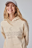 Bild in Galerie-Betrachter laden, The Moon Doesn’t Explain Its Phases – Neither Do I – Luxury Line Embroidered Hoodie in Sandy Beige
